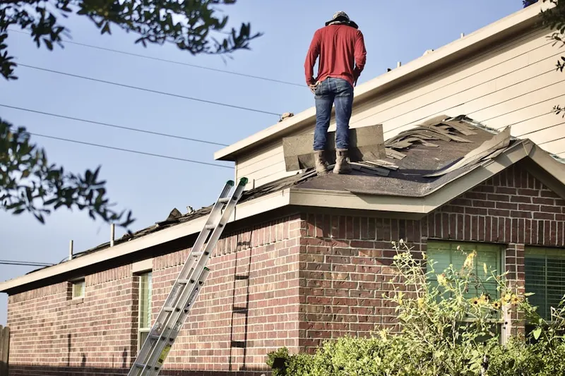 Professional roofer working on a residential roof in Bassett Creek